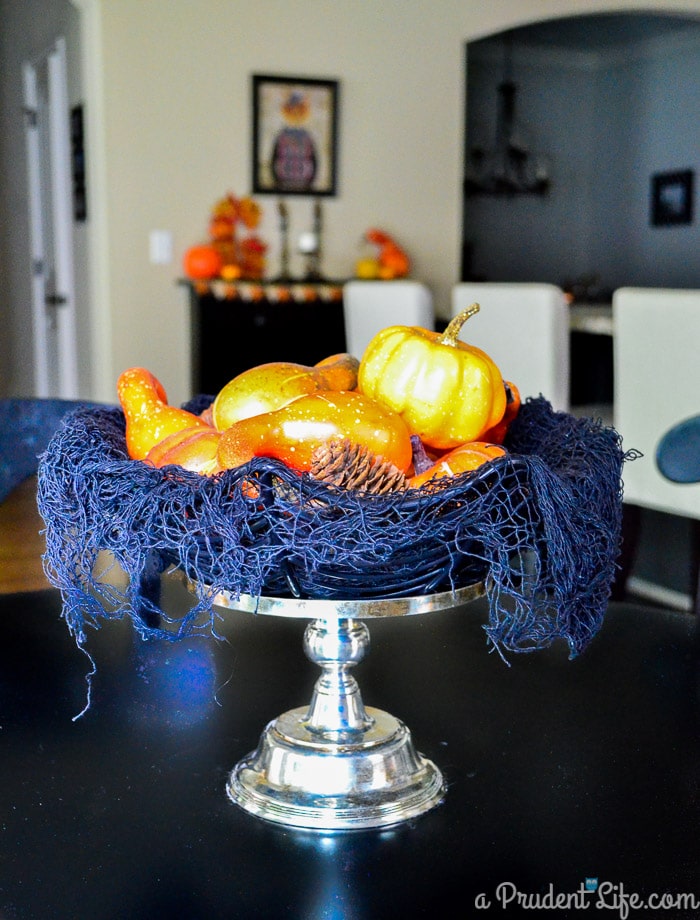 Turn a thrift store candle stick & dollar store materials into a cute Halloween centerpiece in under a minute!