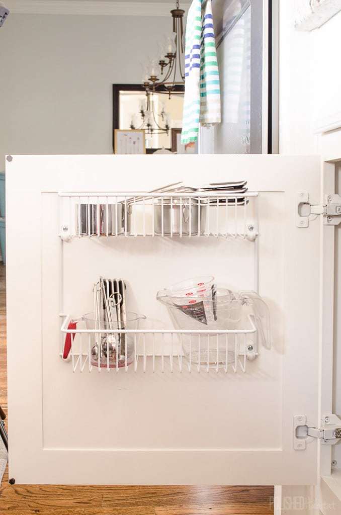 Don't overlook cabinet doors when organizing a kitchen. Inexpensive wire shelves are great for measuring cups and spoons! See more kitchen organizing at PolishedHabitat.com