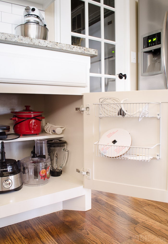 Don't overlook cabinet doors when organizing a kitchen. Inexpensive wire shelves are great for bulky kitchen accessories like KitchenAid mixer attachments! See more kitchen organizing at PolishedHabitat.com