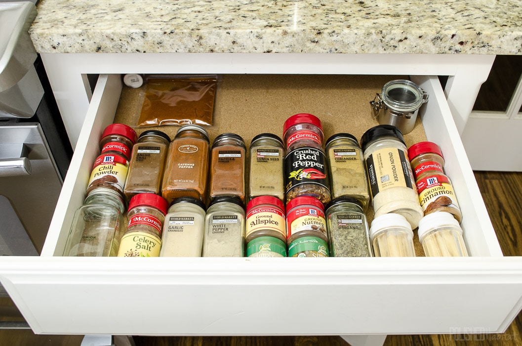 Use a drawer to store spices. Click for more cabinet organizing ideas from Polished Habitat.