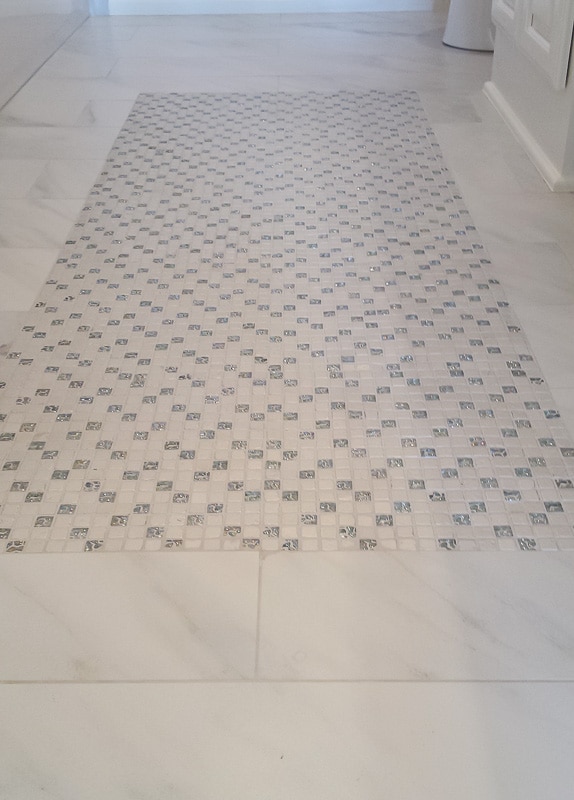 Glittered tiles make a fun rug in otherwise traditional marble tile for a timeless kids bathroom.
