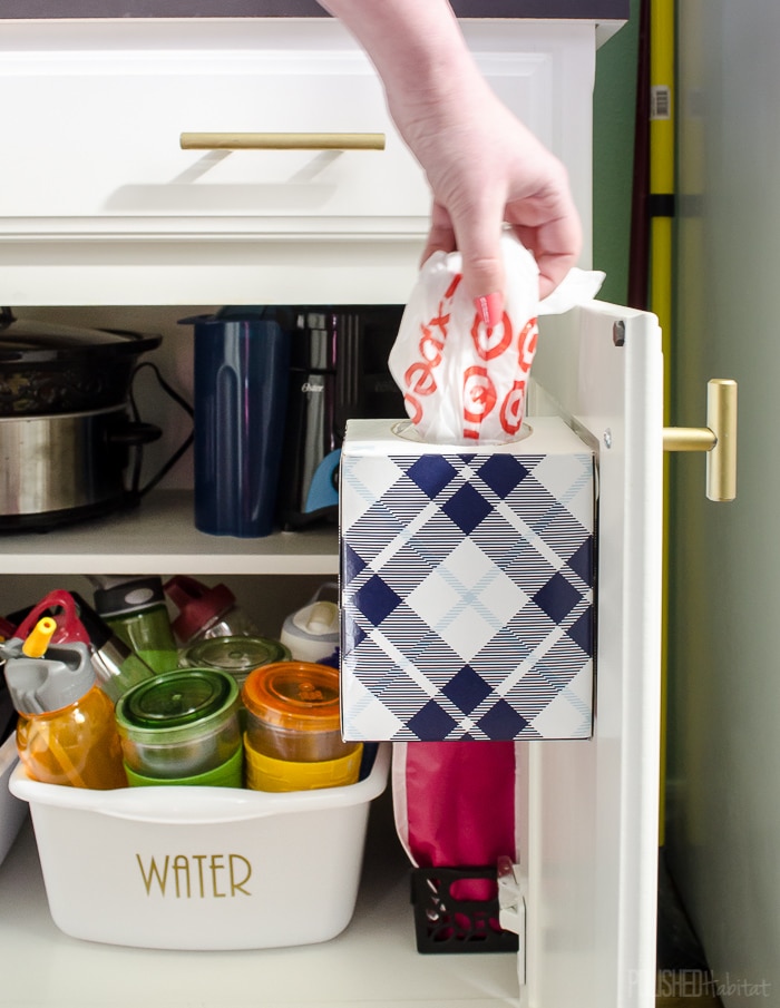 Brilliant! Use a tissue box on the inside of a cabinet door to store plastic bags. Click to see all 6 cabinet organizing tips!