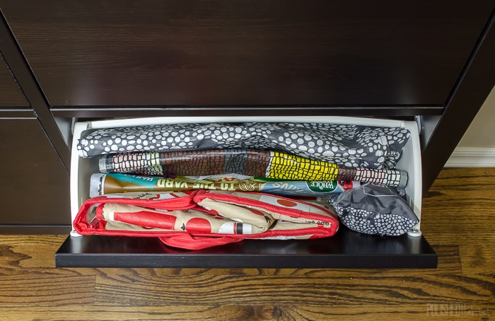 Use an IKEA shoe cabinet to add kitchen storage. One of the 14 ideas in this post is to use one drawer for reuseable grocery bags. Click to see the other 13 ideas! 