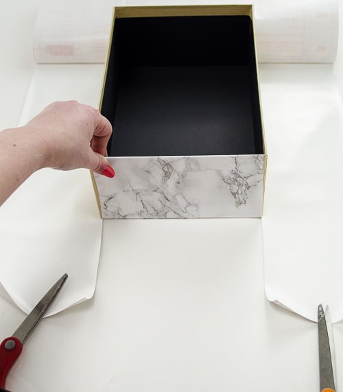 Marble contact paper plus an inexpensive photo box can be combined into inexpensive chic storage. Love the tips on how to make the corners look good! 