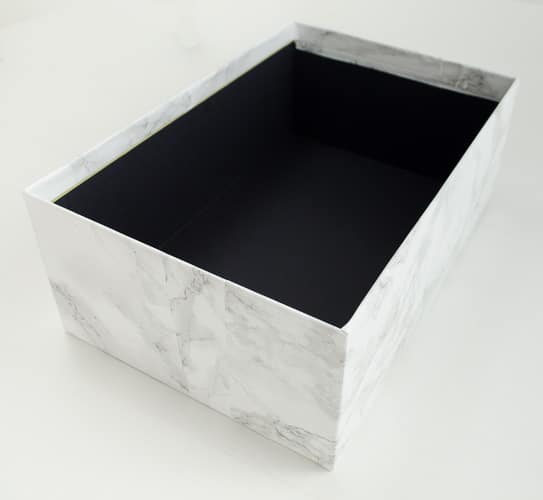 Marble contact paper plus an inexpensive photo box can be combined into inexpensive chic storage. Love the tips on how to make the corners look good! 