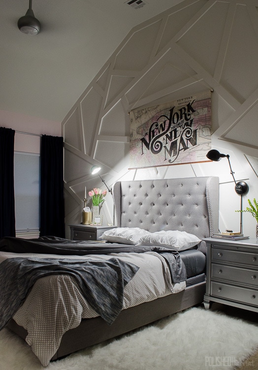 Modern bedroom with unique feature wall and gray tufted headboard. Love the pink walls! 