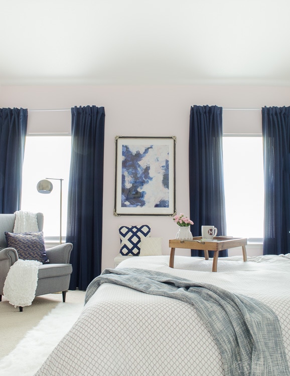 Gorgeous master bedroom with dramatic navy drapes. It's so glam and cozy at the same time.