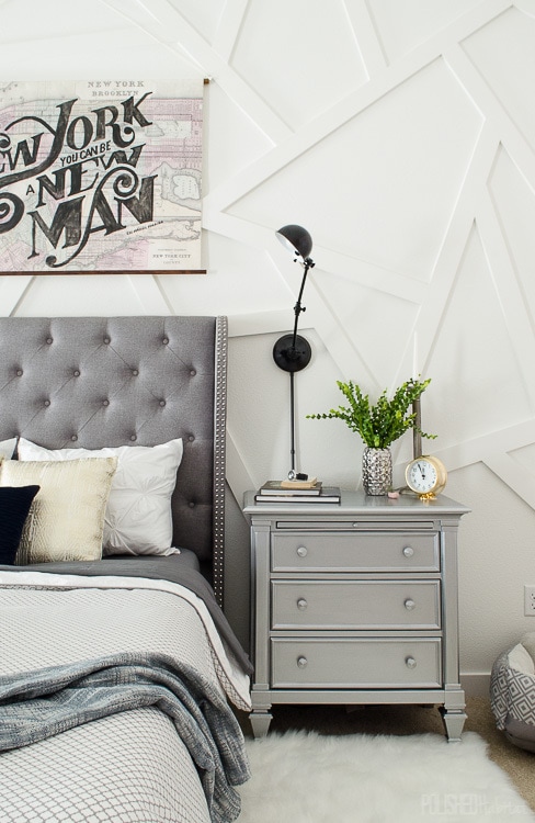 This silver nightstand was a DIY that works perfectly in this modern master bedroom. Love that gray tufted headboard! 
