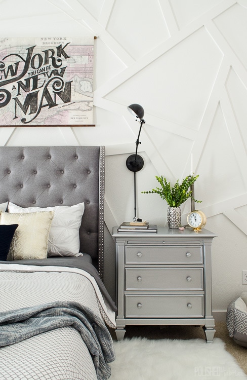 This silver nightstand was a DIY that works perfectly in this modern master bedroom. Love that gray tufted headboard!