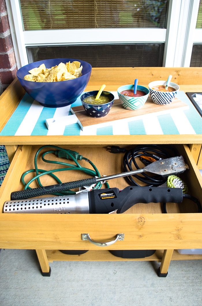 Get the patio organized AND add serving space with this affordable potting bench. It works as the perfect bar and has both drawer and shelf space. Love it!