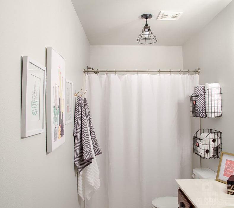 Budget Bathroom Makeover - This guest bathroom went from boring beige to organized modern industrial style in one weekend for under $300.