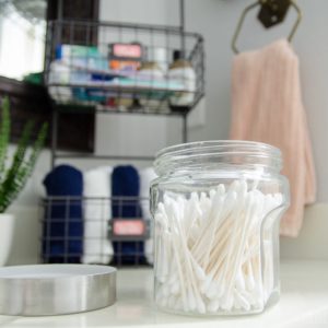 Inexpensive containers from Hobby Lobby make bathroom organization easy AND chic!