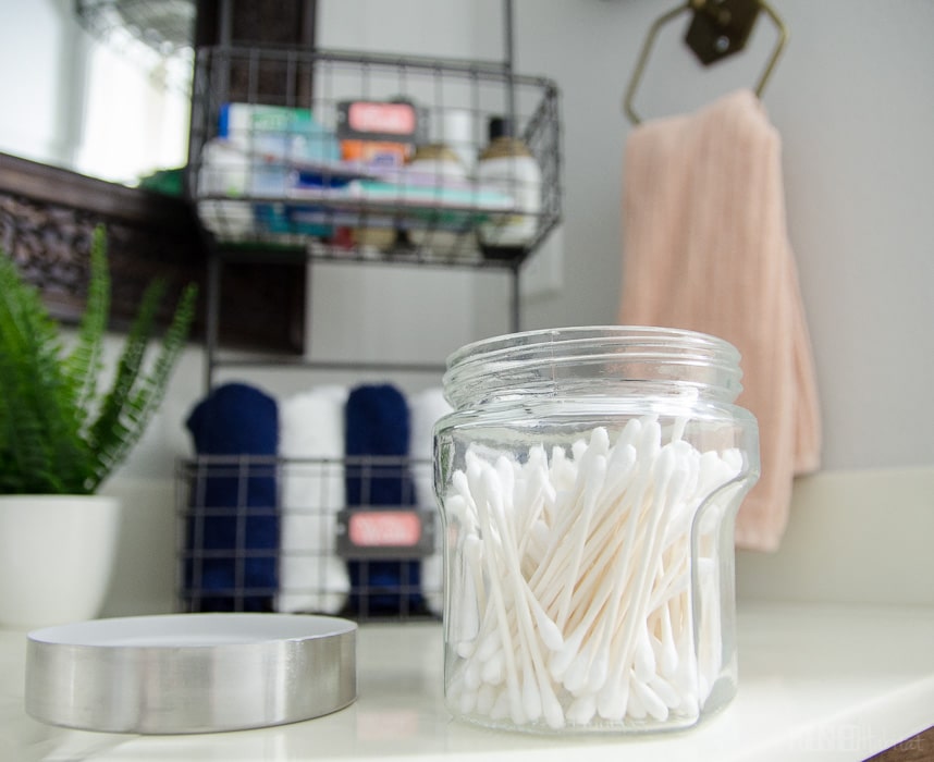 Inexpensive containers from Hobby Lobby make bathroom organization easy AND chic! 