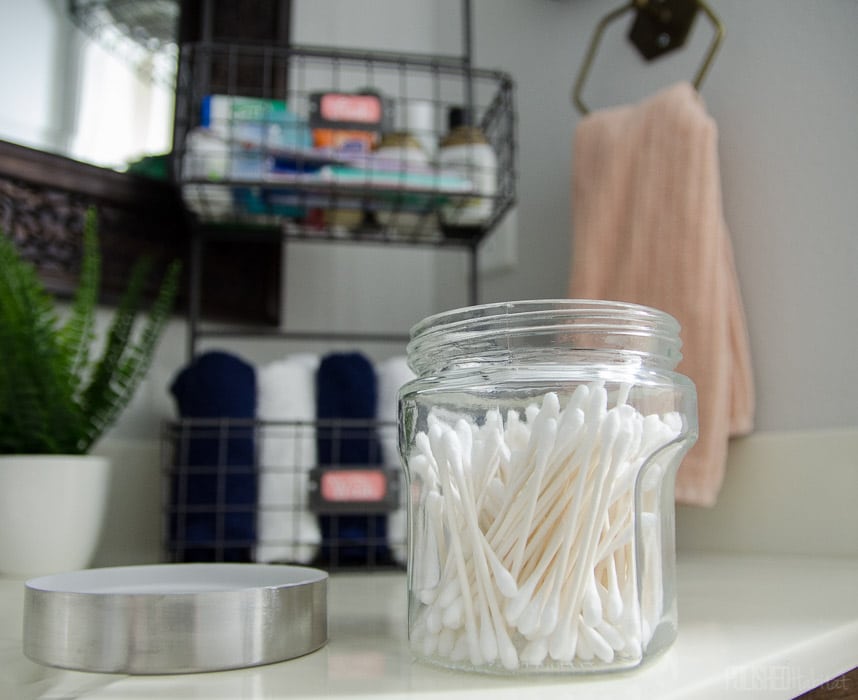 Inexpensive containers from Hobby Lobby make bathroom organization easy AND chic!