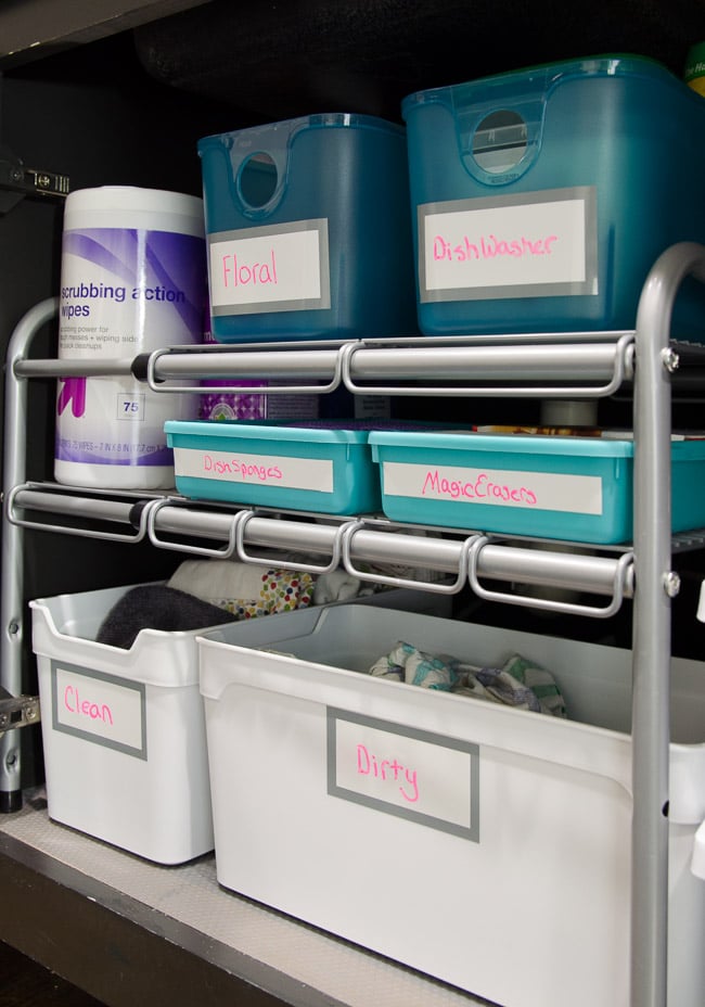 Organized cabinet under the kitchen sink with dirty towel storage