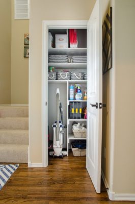 Organized cleaning closet with space for vacuum and other supplies