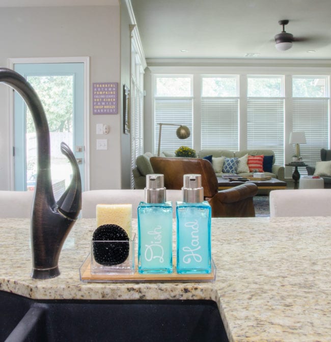 Organized kitchen sink area with space for soap and sponges