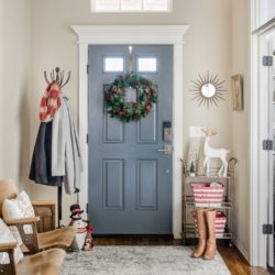 Entryway with gray door and vintage seating