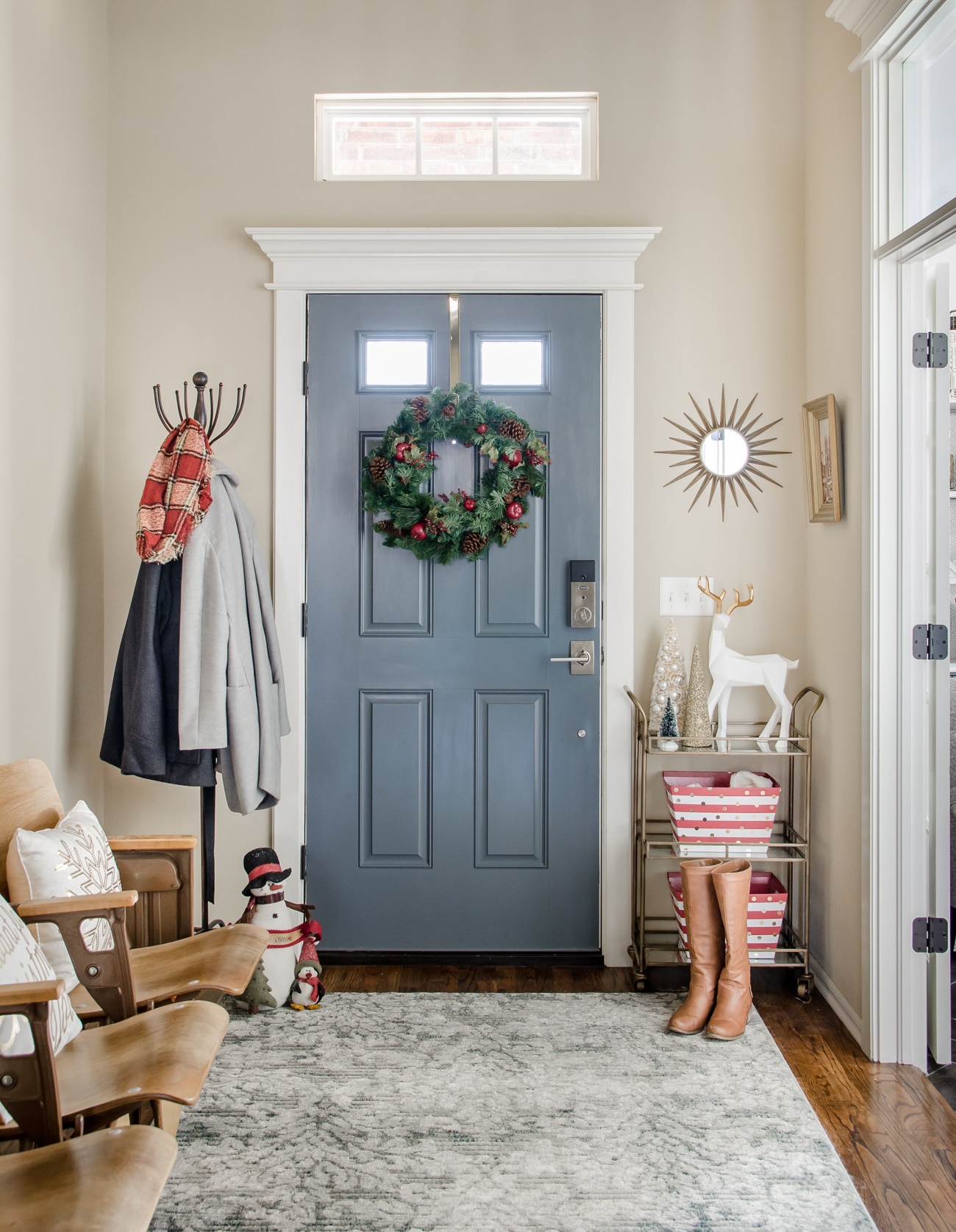 Entryway with gray door and vintage seating