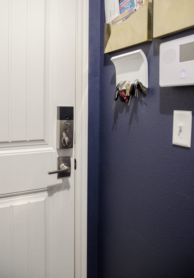 Small organized garage entry with key and mail storage, plus a keypad entry. 