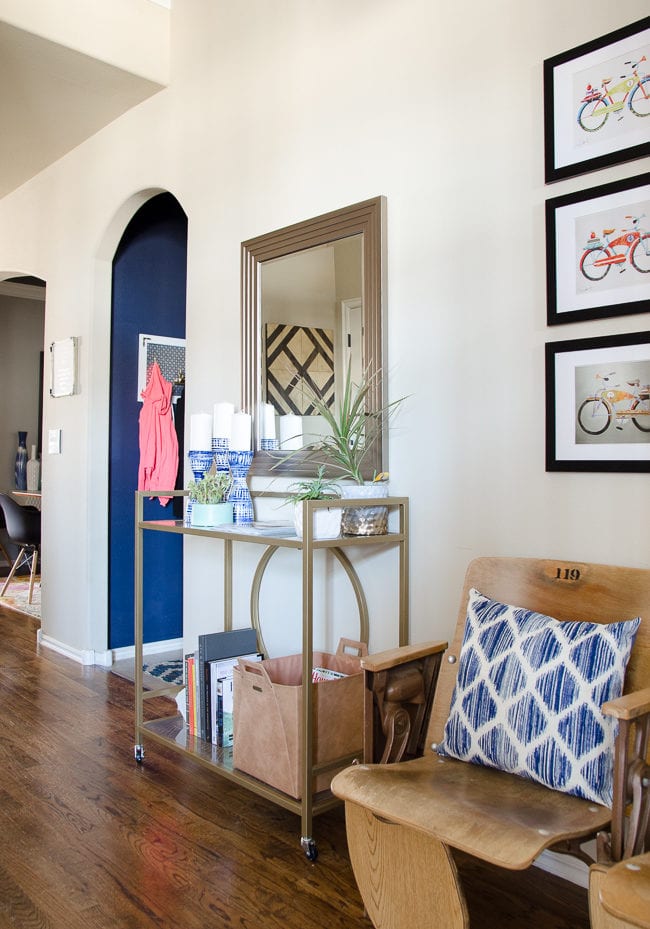 Entryway with organization for magazines and vintage theater seats.