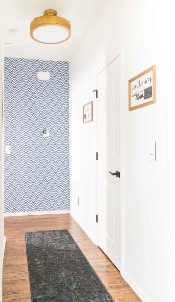 Short hallway with white walls and removeable wallpaper accent