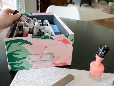 Pretty floral storage box containing nail polish / manicure supplies.