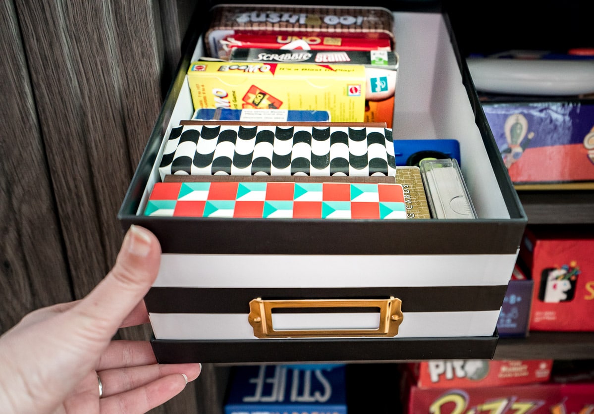 Small card games organized in a black and white photo box.