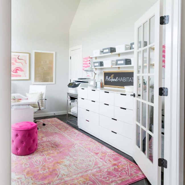 White home office with lots of storage drawers and shelves
