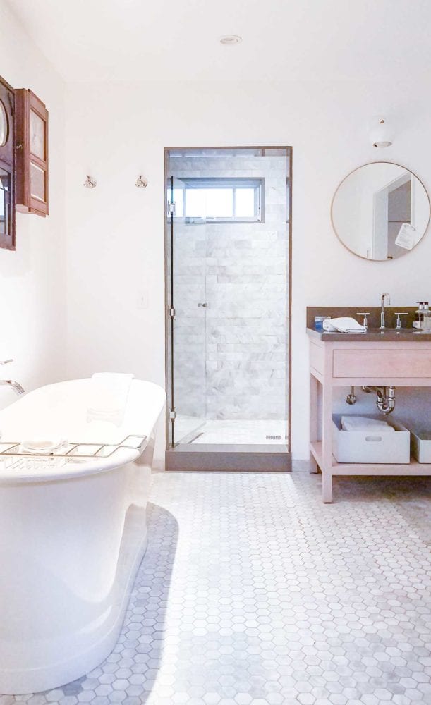 White Bathroom with freestanding tub, marble floors, and marble shower Vagabond House Inn