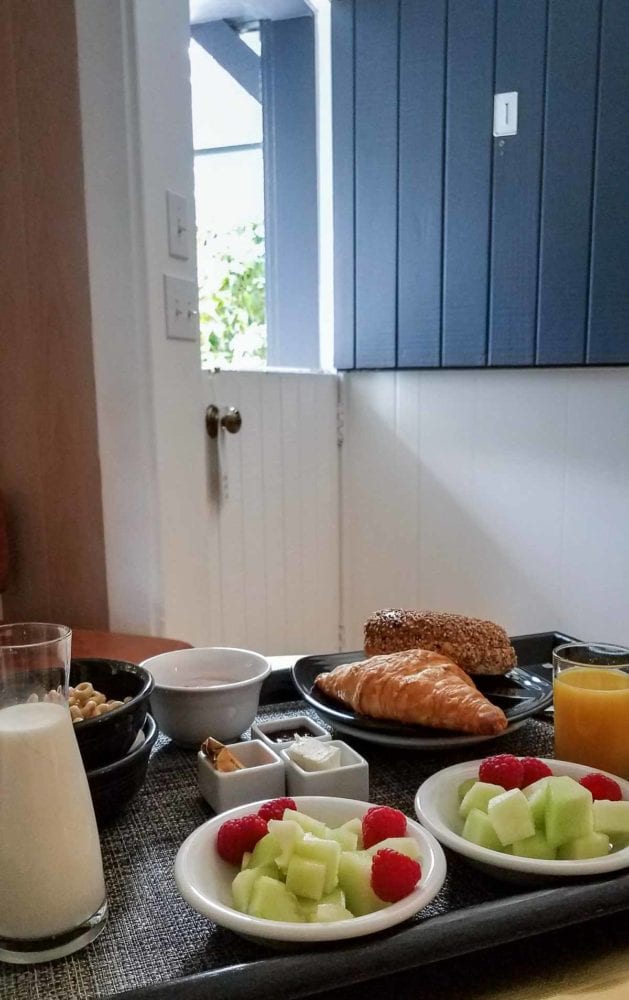 Fruit and croissant breakfast on a tray 