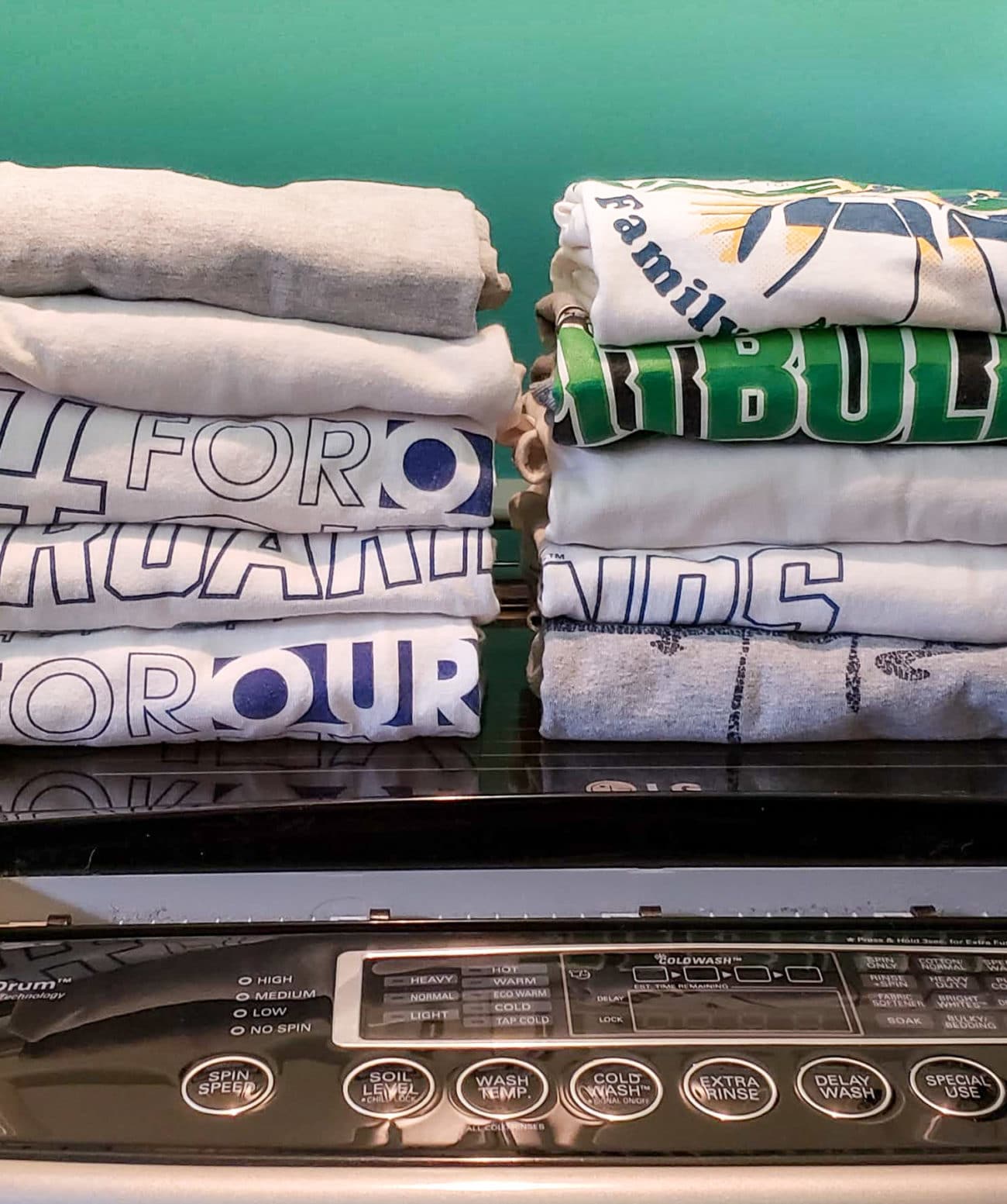 Neatly staccked tshirts on washing machine