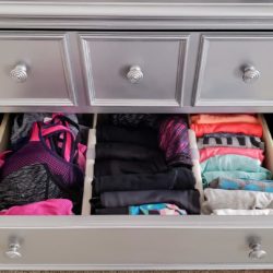 Sports bras, yoga pants, and tank tops organized in a drawer