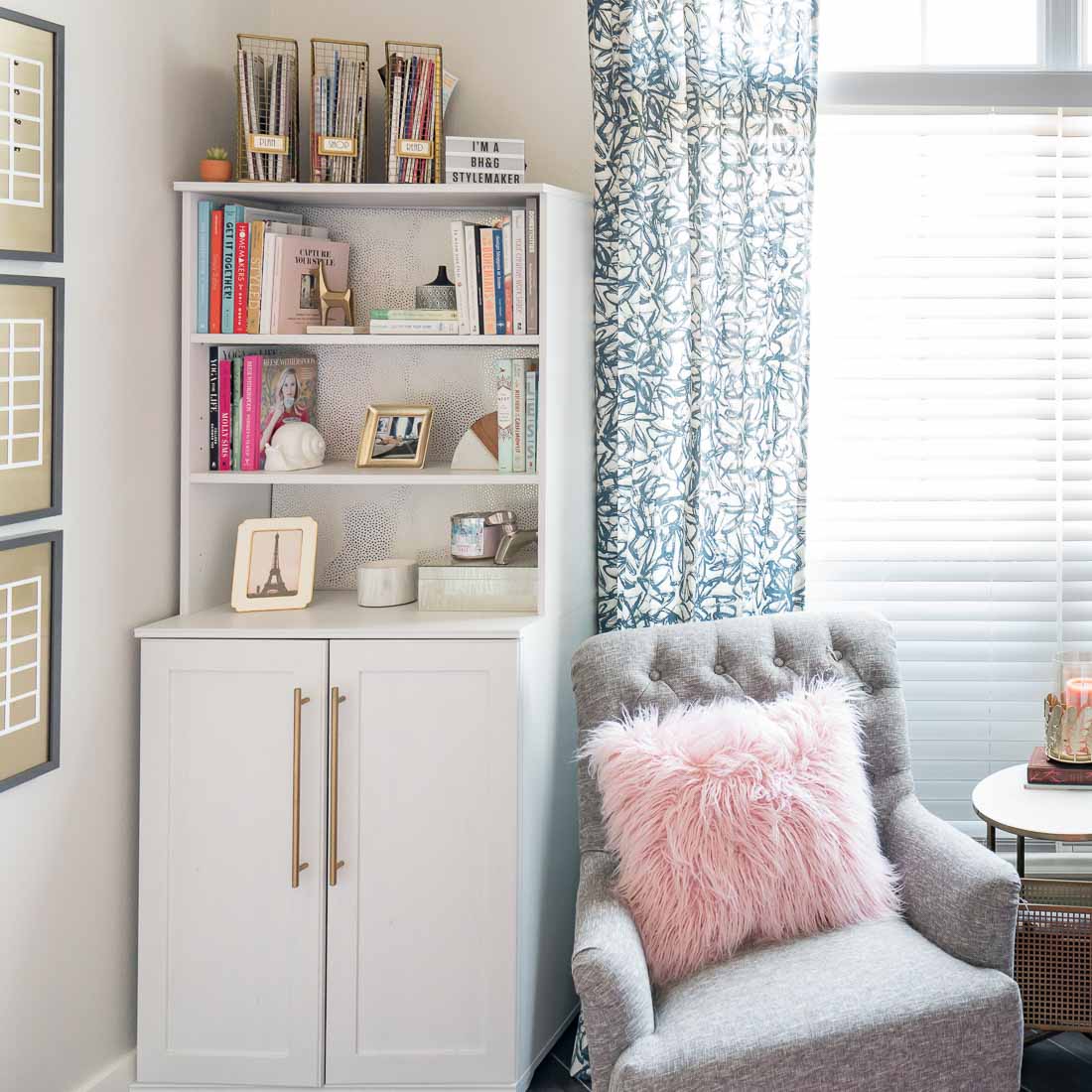 White bookcase in feminie office with gray chair and pink pillow 