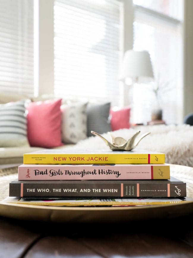 Books on gold tray in living room