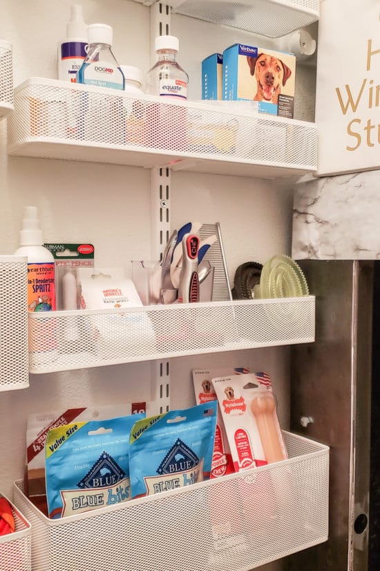 Organized dog supplies in a wall mounted storage unit