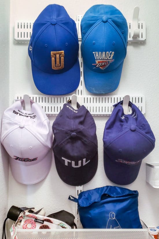 Blue baseball hats mounted on wall.