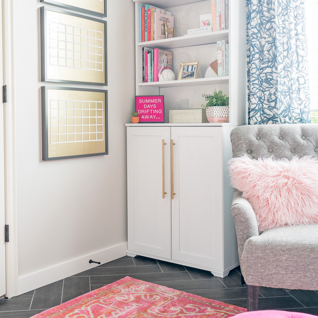 White bookcase with pink letterboard that says Summer Days Drifting Away