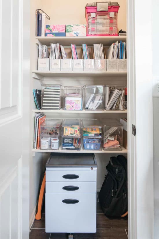 Closet with shelves full of organized office supplies