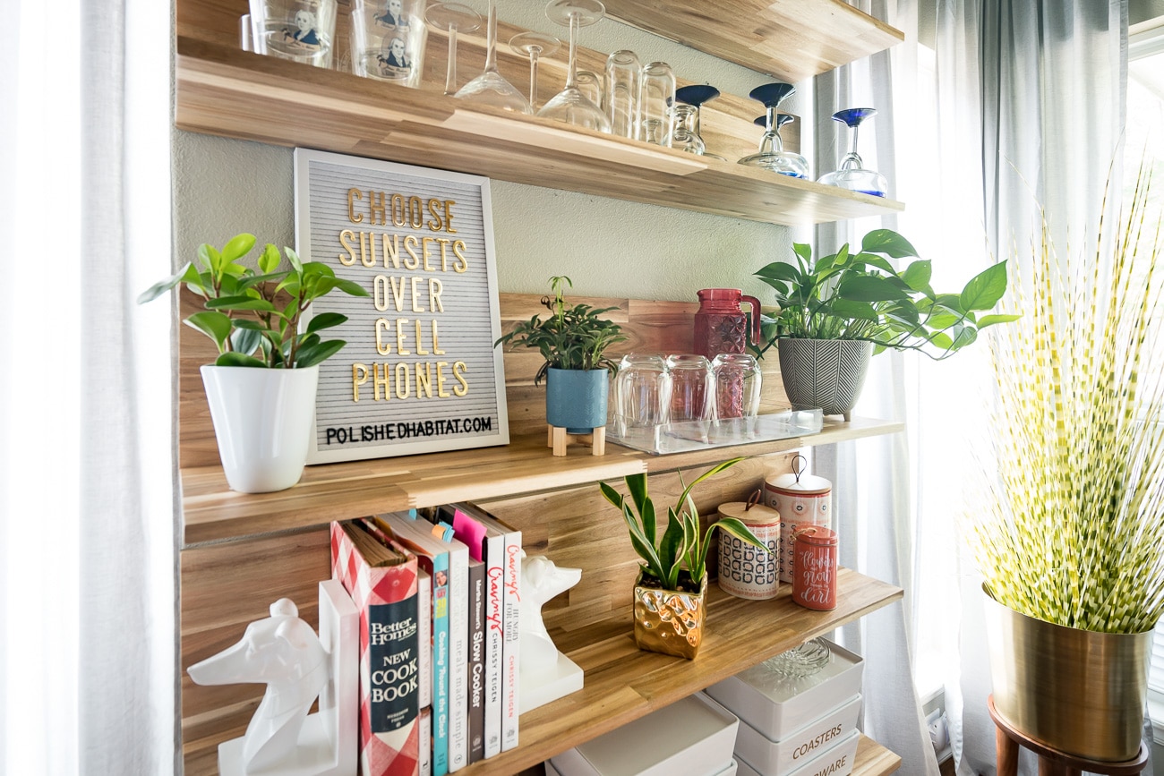 Wood shelves with white letter board saying - Choose Sunsets Over Cell Phones