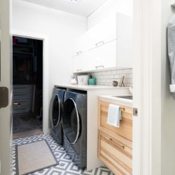 Small Laundry room with marble countertop and sink and wood cabinet