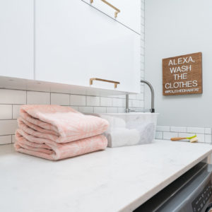 White laundry room - cabinets, counter & subway tile