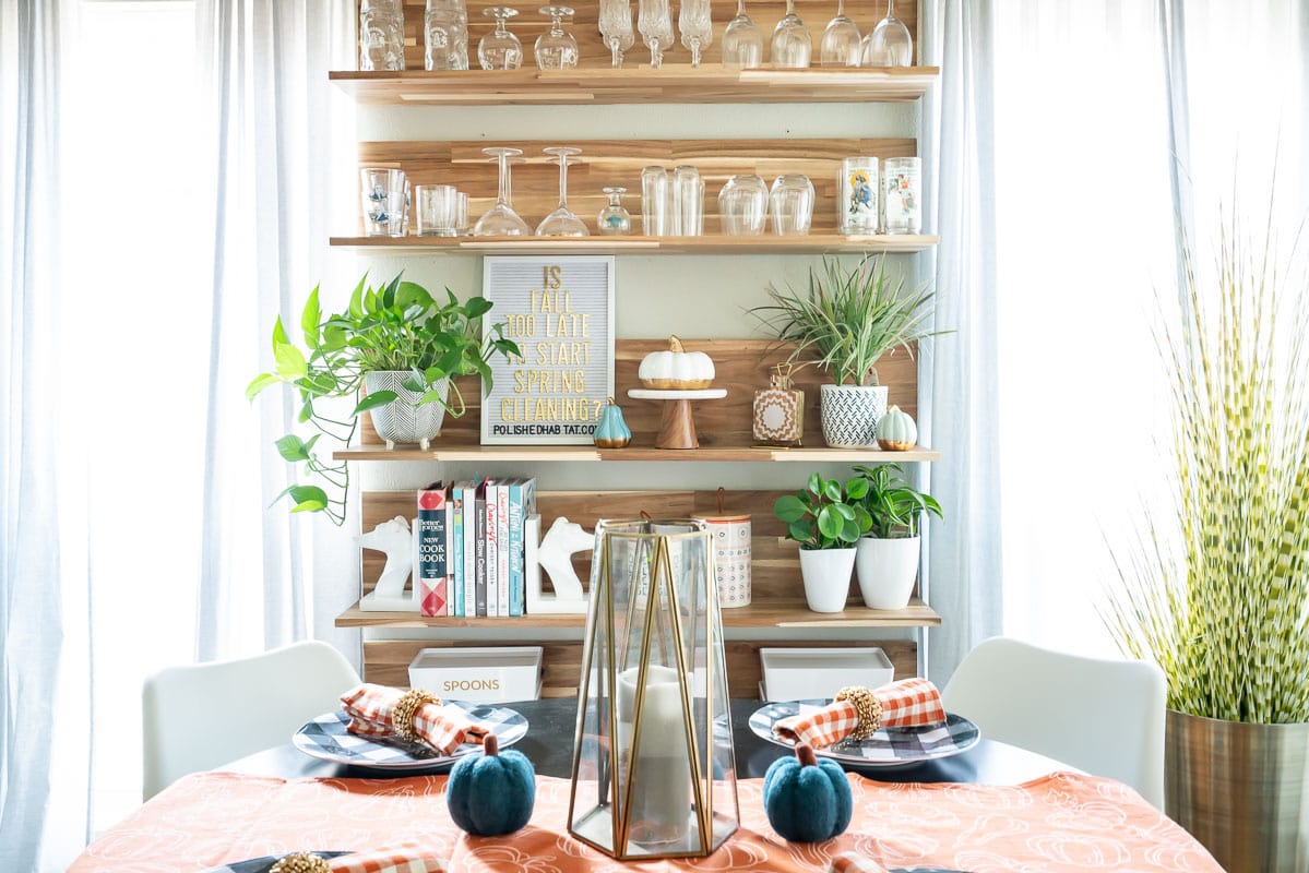 Kitchen nook with wood shelves between windows