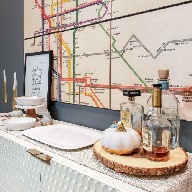 Console table in dining room set up as a bar