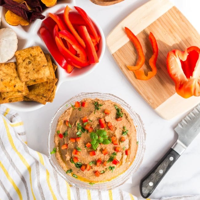 mediterranean hummus in bowl with red pepper and crackers