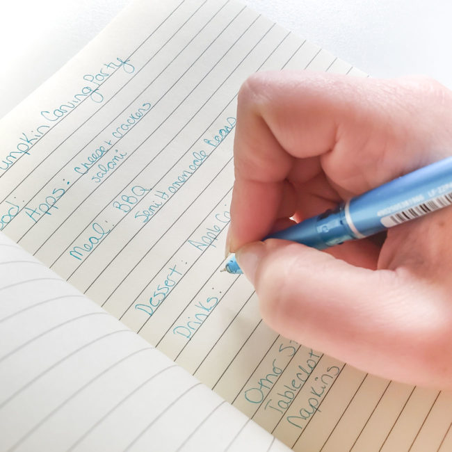 Blue pen writing in notebook