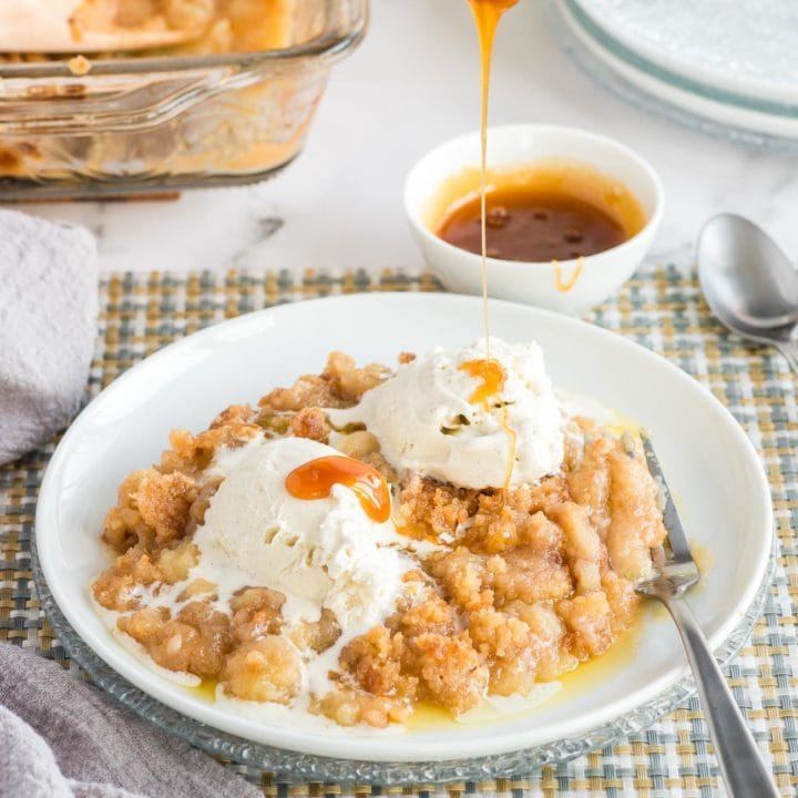 Caramel being drizzed onto apple crisp and ice cream