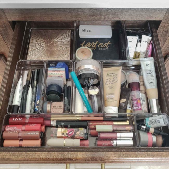 Clear drawer organizers in a bathroom for makeup