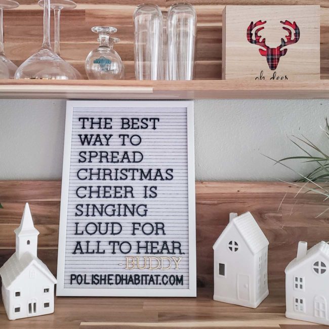 White letter board with black letters on wood shelf for Christmas