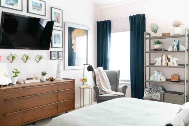 Mid-century modern master bedroom with wood dresser and grey bookcase